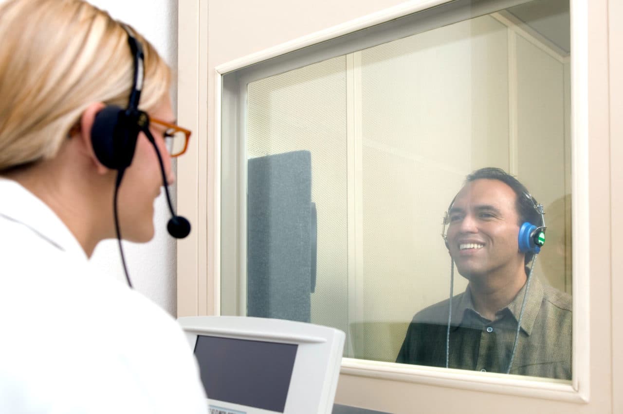 Audiologist conducting hearing test