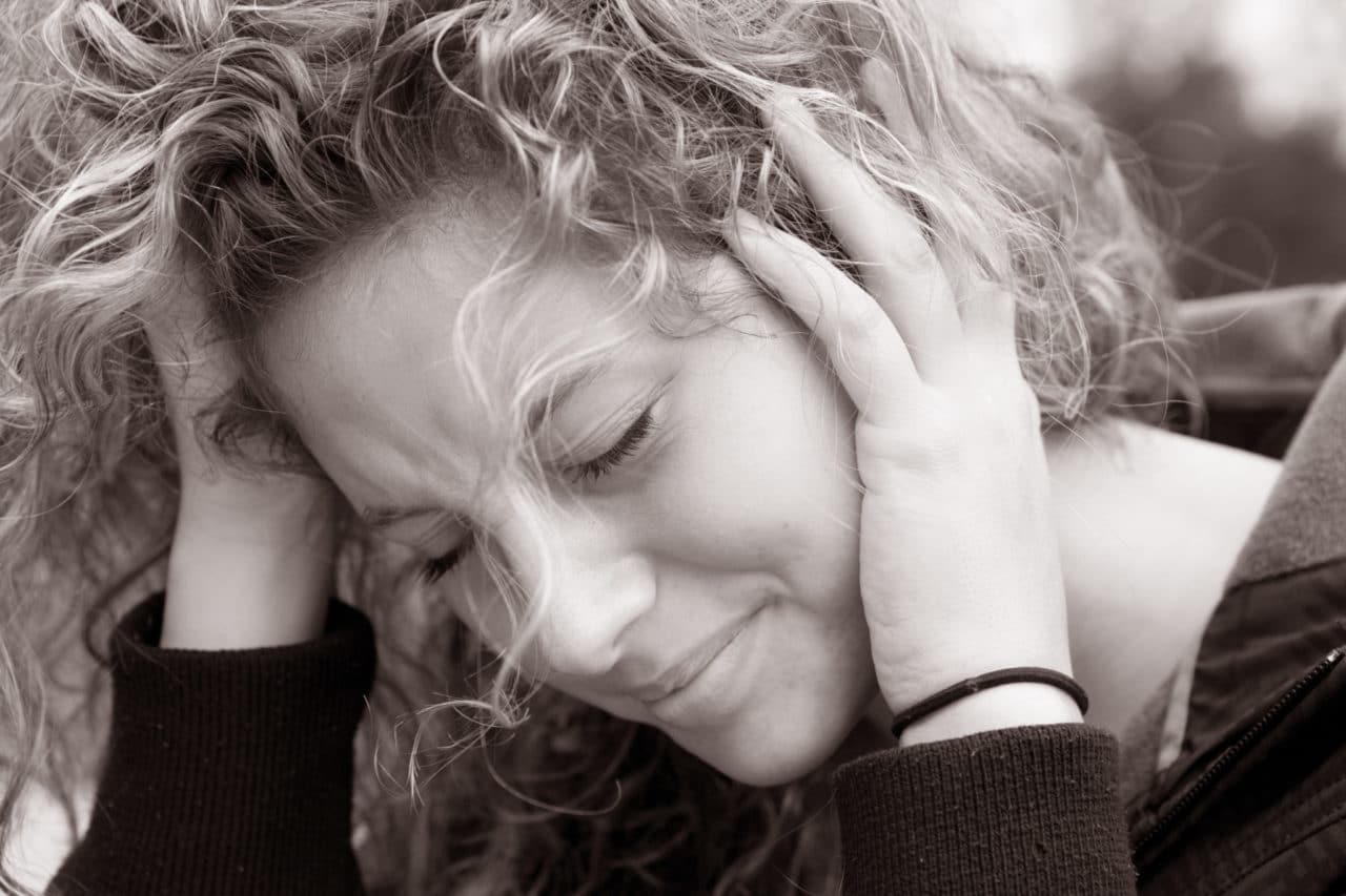 Woman holding her head