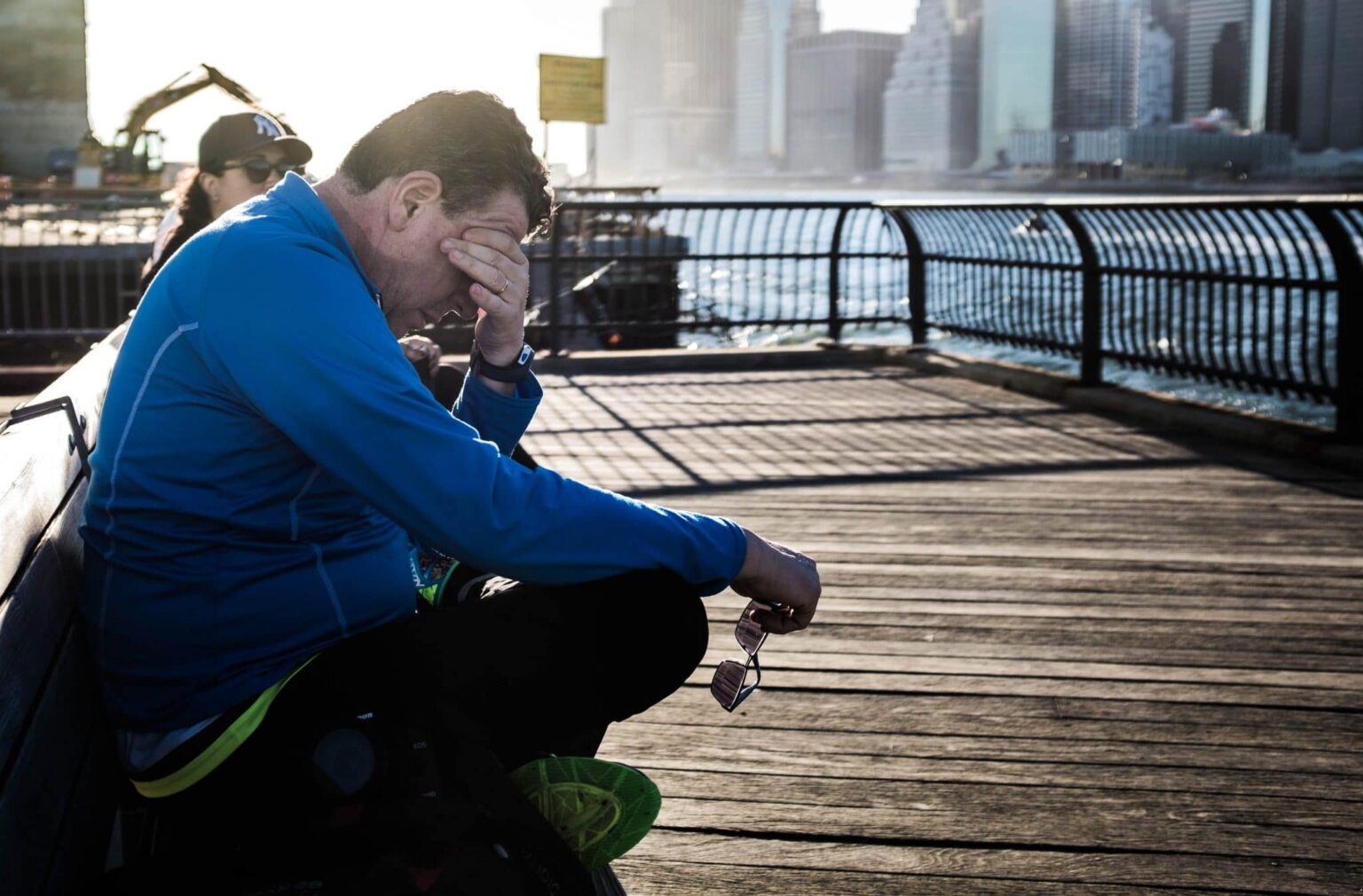 Man holding his hand to his face while he suffers from fatigue
