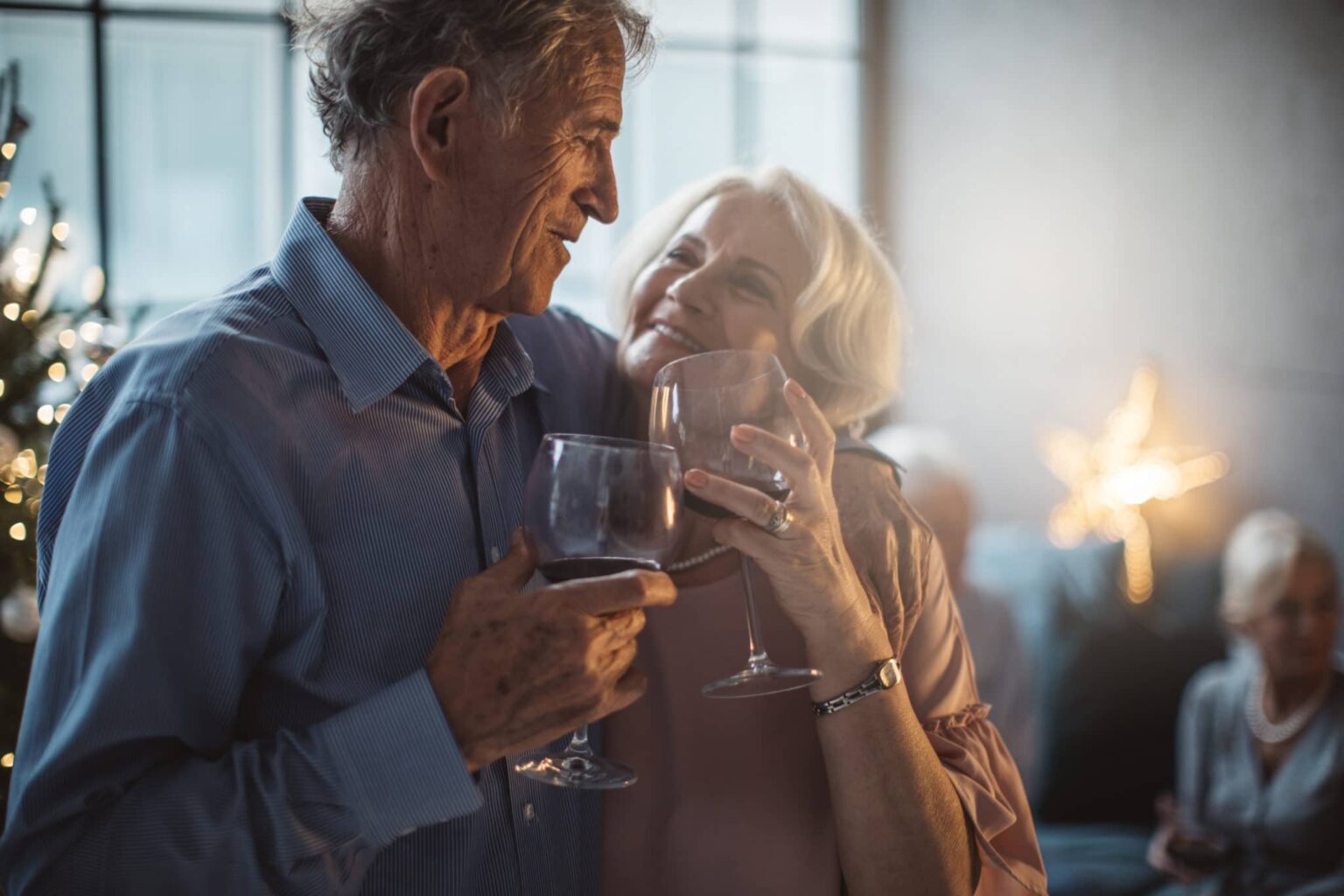 Two older adults enjoying a glass of wine
