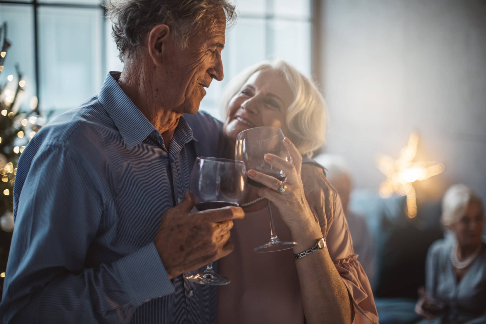 Two older adults enjoying a glass of wine