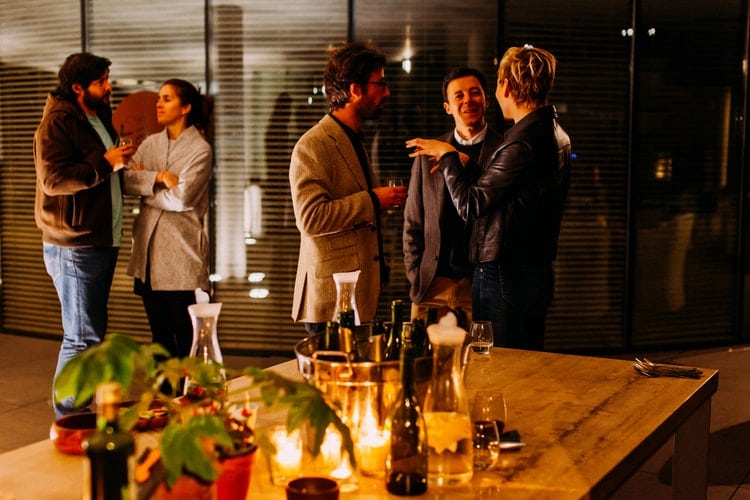 A group of people having a dinner party.