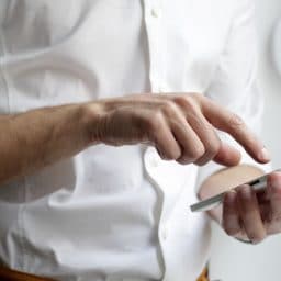 Man linking his smartphone with his hearing aids.