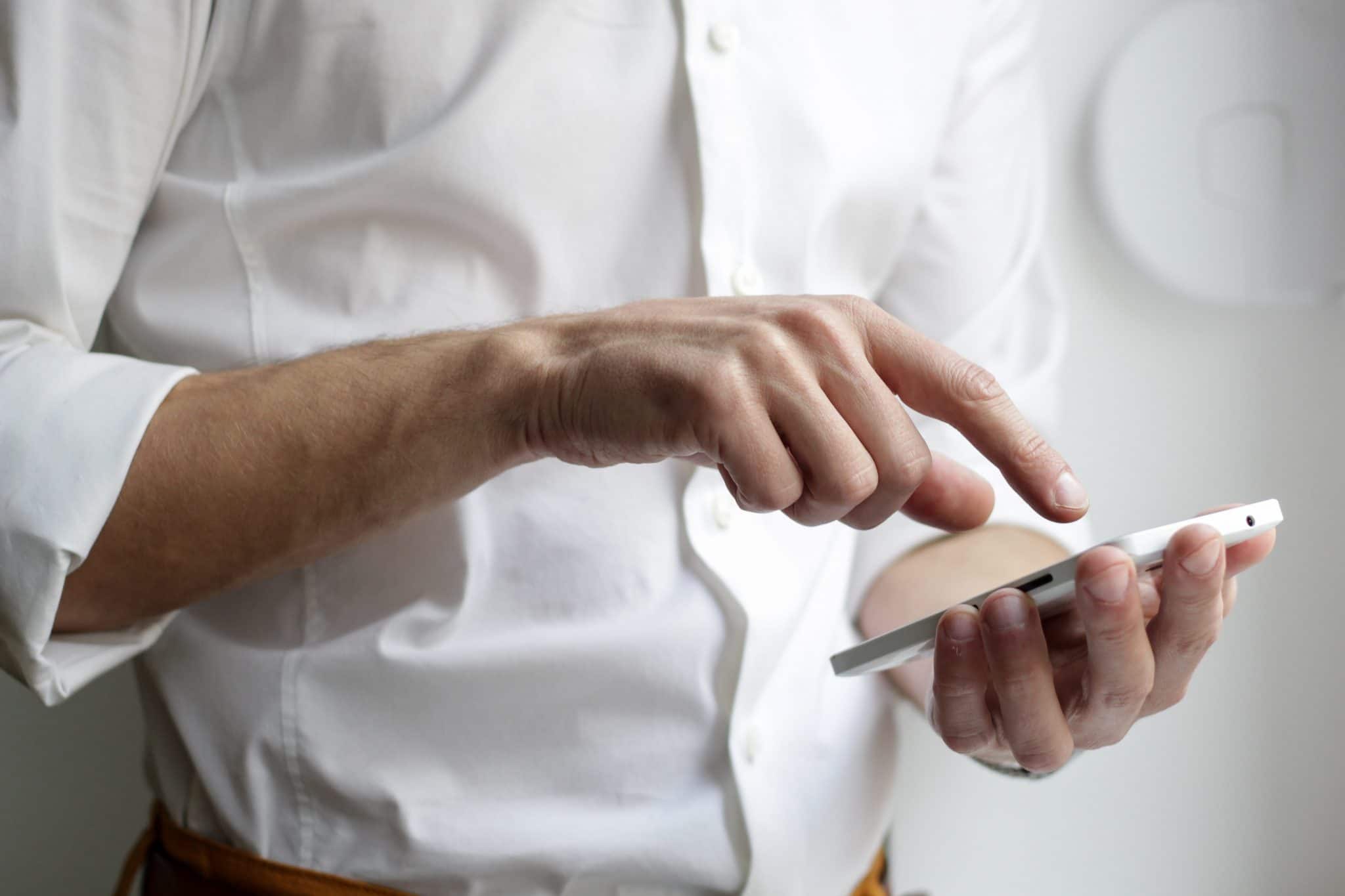 Man linking his smartphone with his hearing aids.