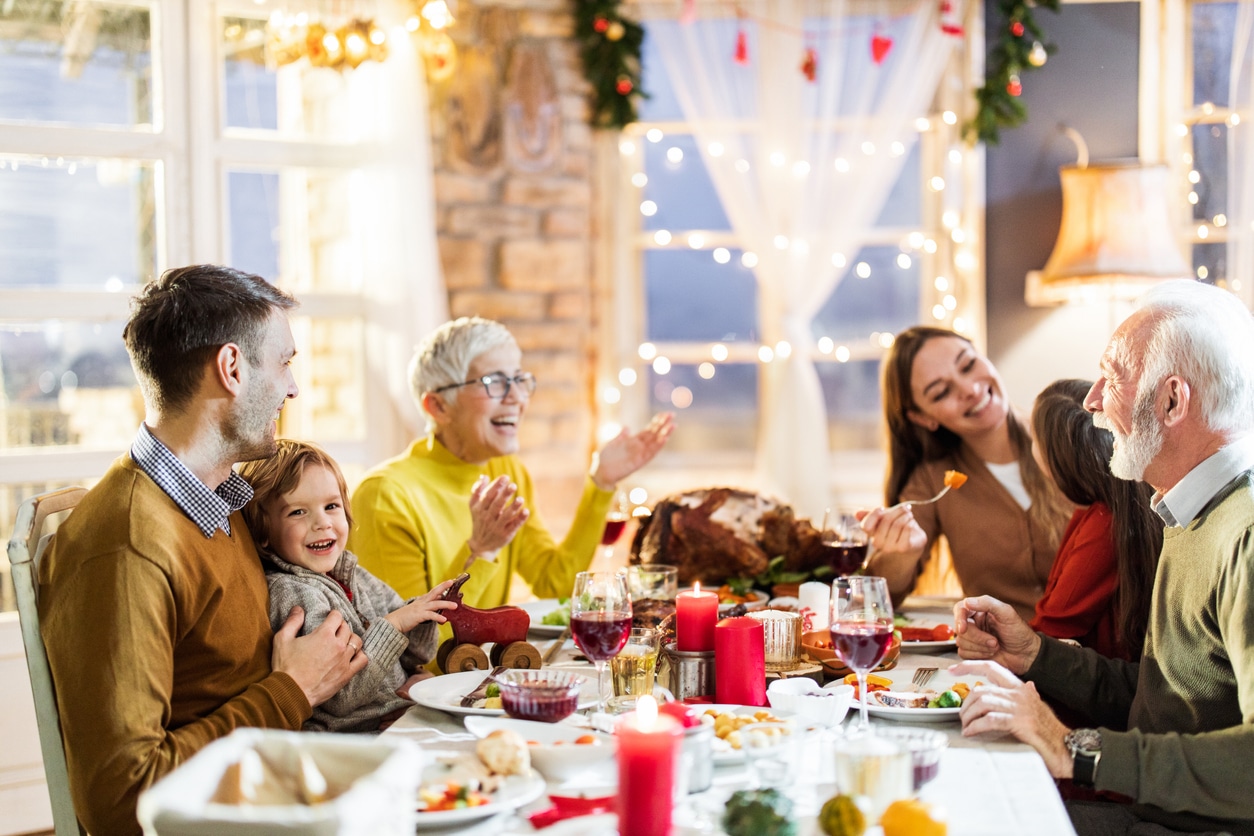 Happy having dinner at dining table. Family eating dinner for the holidays