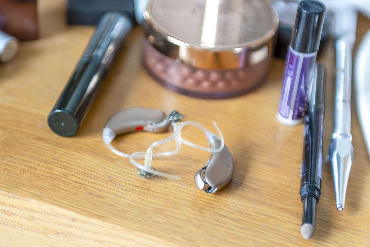 Modern digital hearing aids Image of two hearing aids sitting on a desk