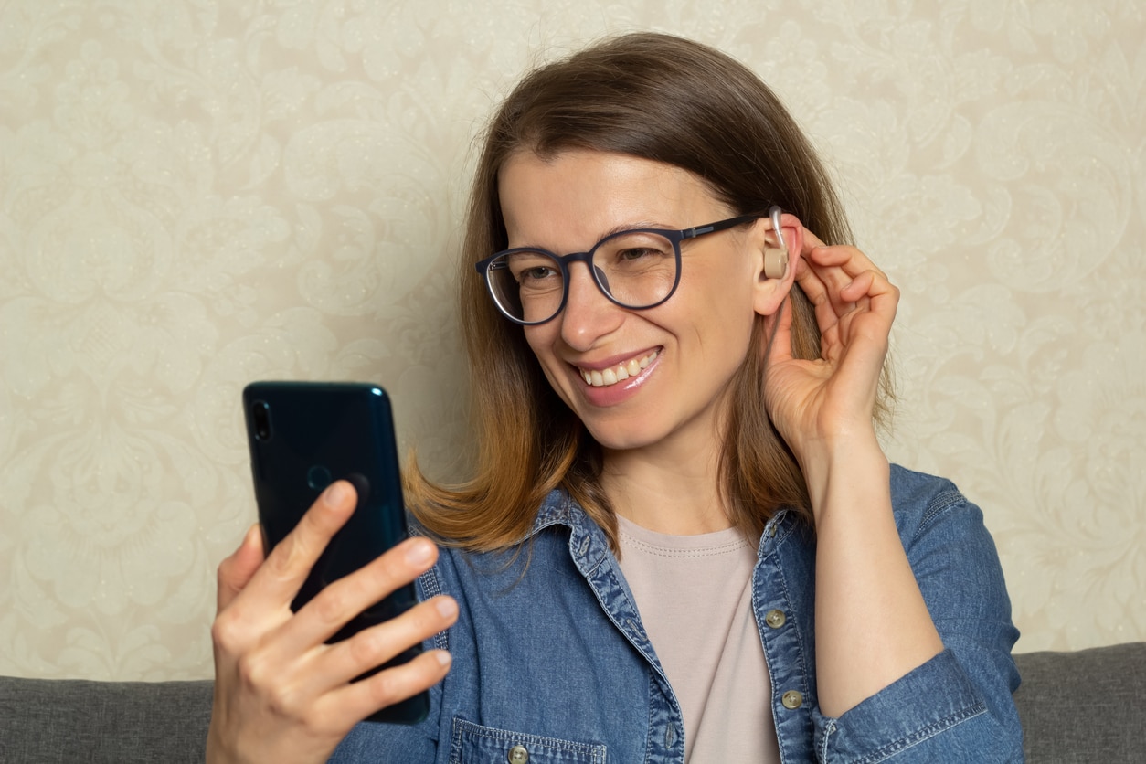 Woman talks on the phone with hearing aids