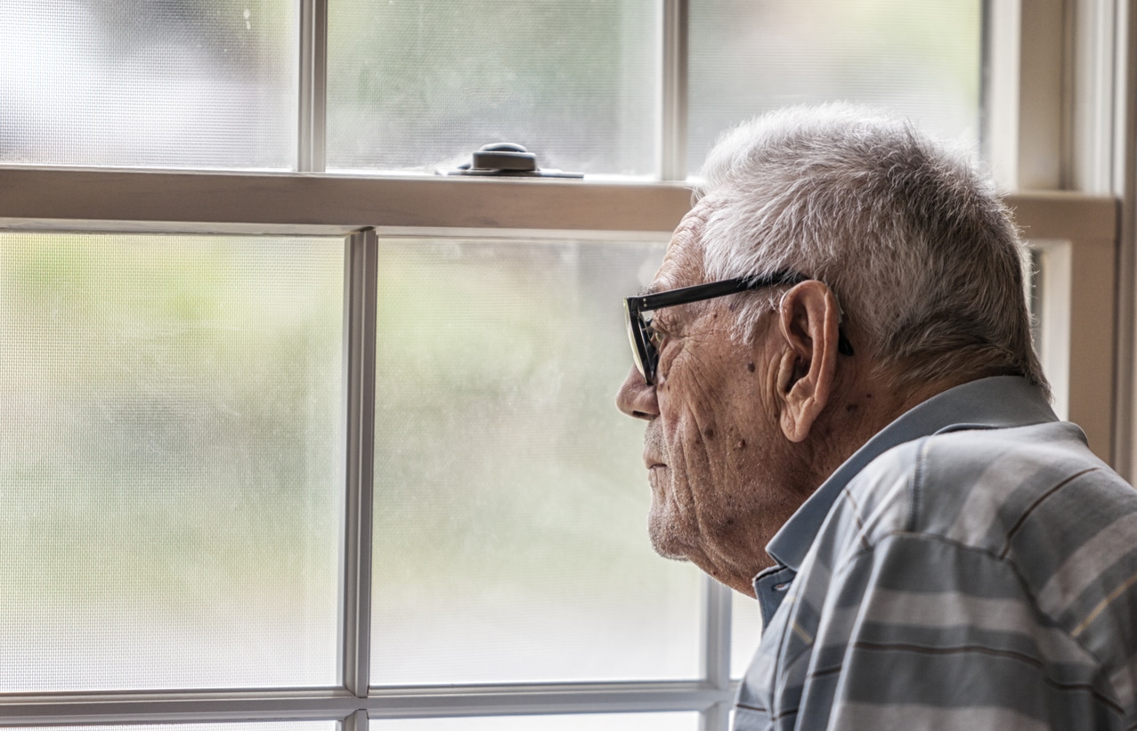 Man stares out window Man stares out window
