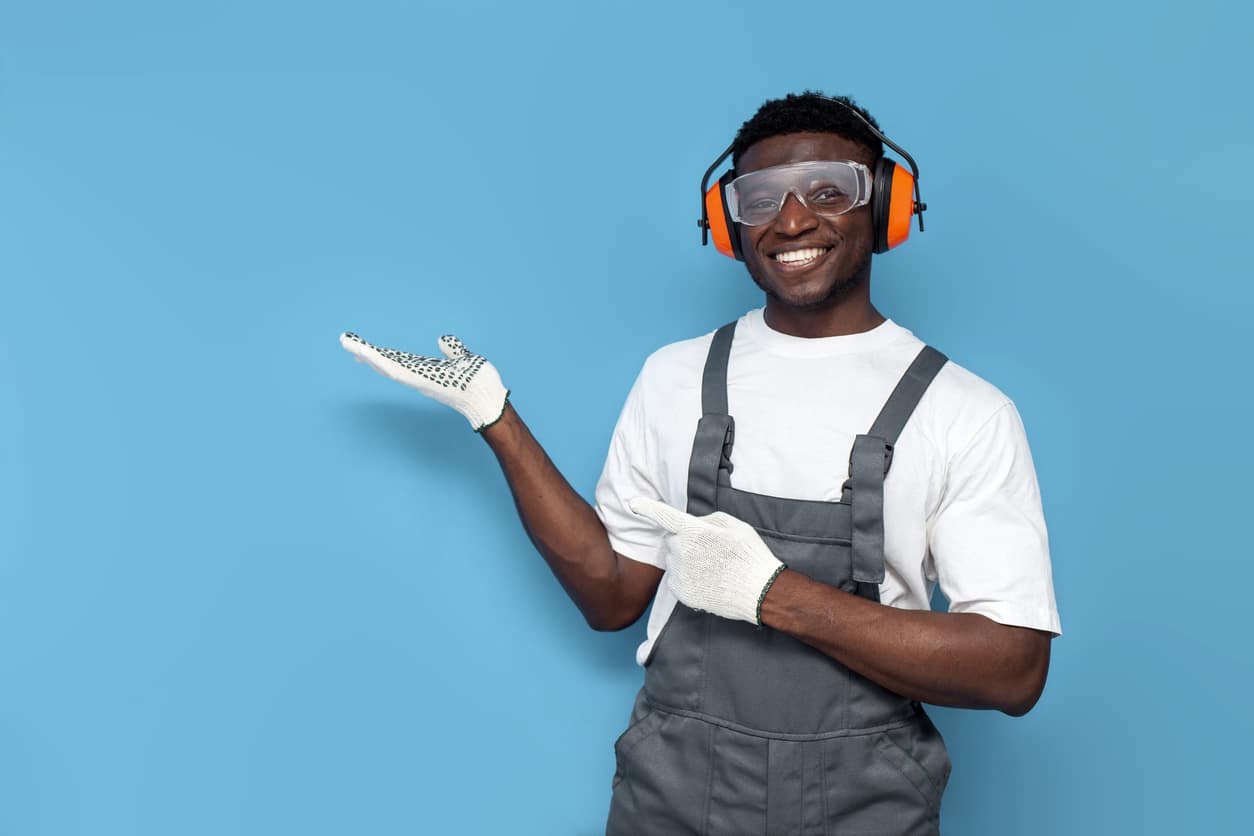 Hearing Protection Young man wearing gloves, goggles and hearing protective equipment
