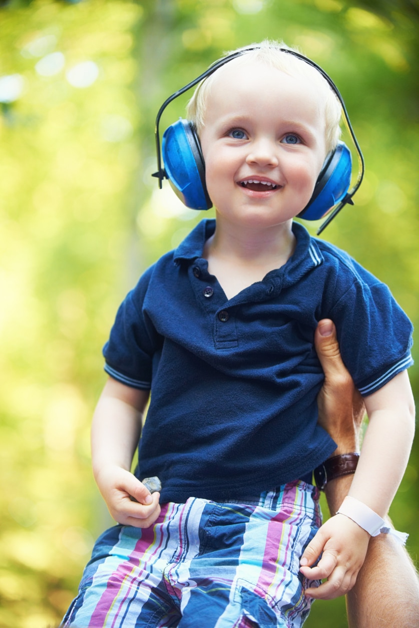 Child with APD wearing earmuffs Child with APD wearing earmuffs